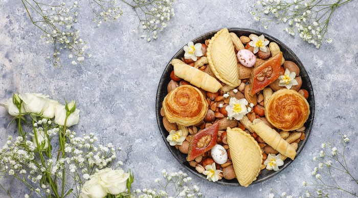 Sweets and nuts on a platter with flowers