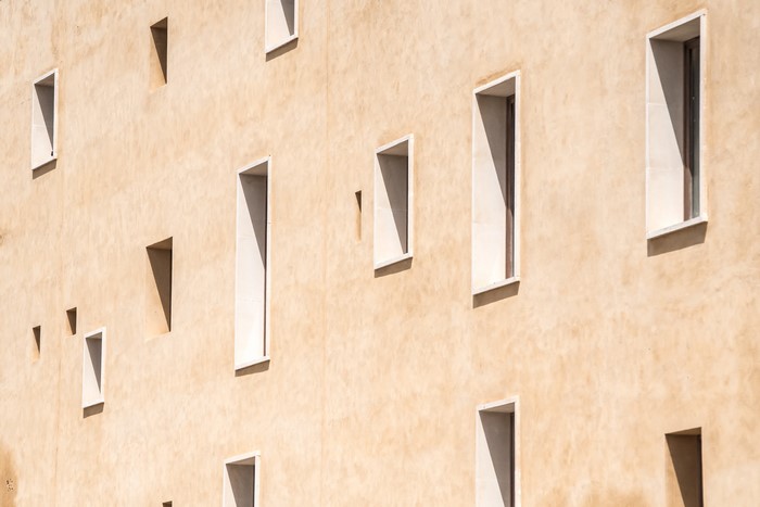 Beige building facade with many windows