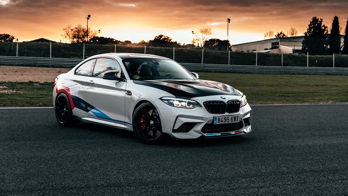 BMW M2 on a race track at sunset