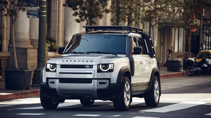 White Land Rover Defender SUV on a City Street