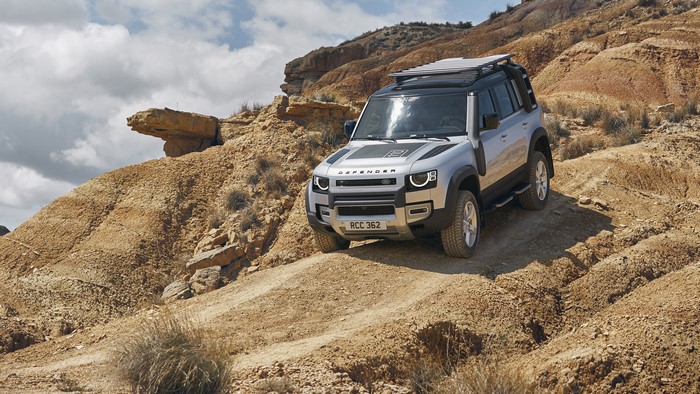 Land Rover Defender SUV off-roading in desert