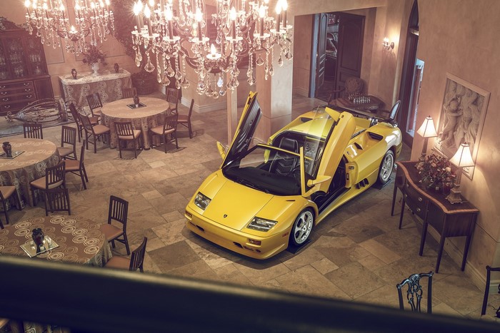Yellow Lamborghini Diablo with Scissor Doors in a Grand Room