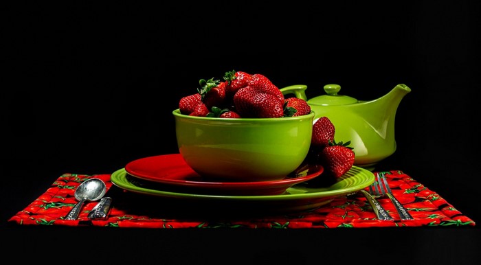 Still life with strawberries, plates, and teapot
