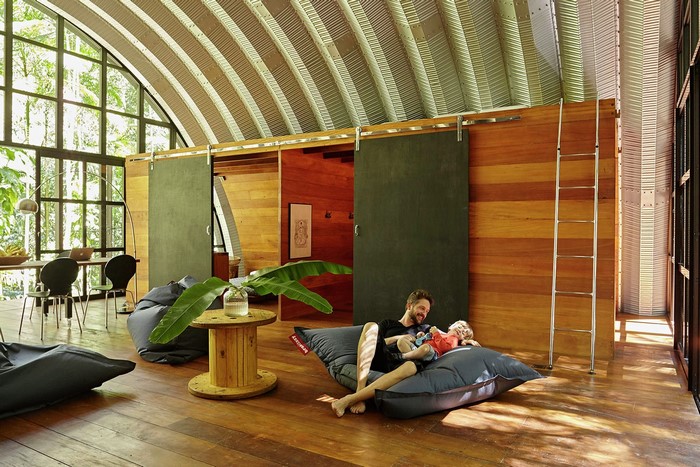 Father and son relaxing in a modern wooden house