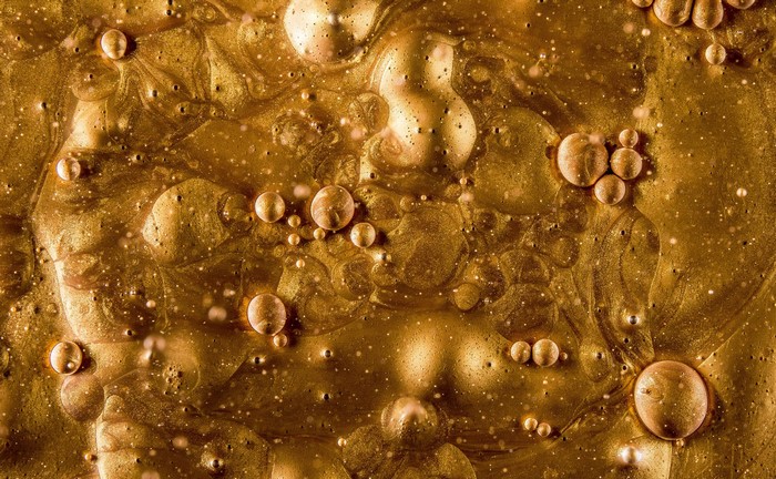 Abstract gold liquid with bubbles