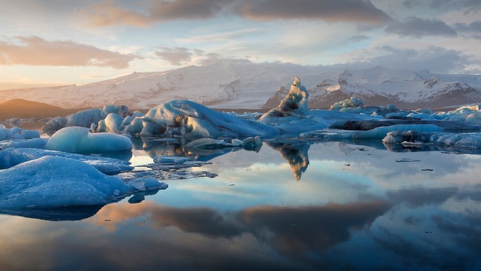 Icebergs floating in a lake with snowy mountains in Iceland
