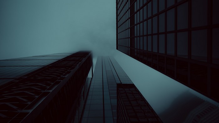 Skyscrapers shrouded in mist at night