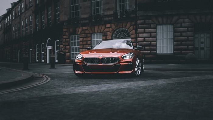 Orange BMW Z4 on a Cobblestone Street