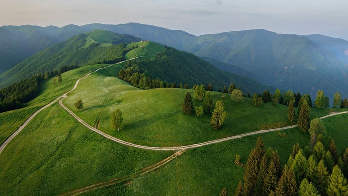 Aerial view of green mountains and paths in Veneto, Italy