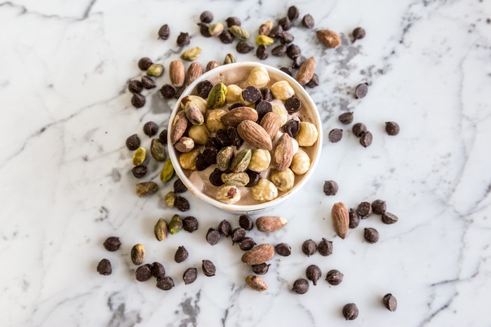 Bowl of nuts and chocolate chips on marble