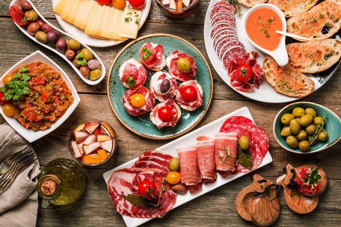 Tapas spread with charcuterie, cheese, olives, and bread