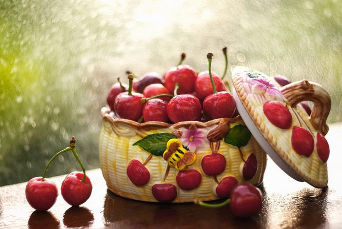 Cherries in a decorative ceramic bowl