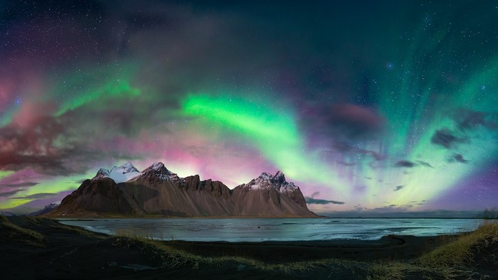 Aurora Borealis over Vestrahorn mountains and black sand beach