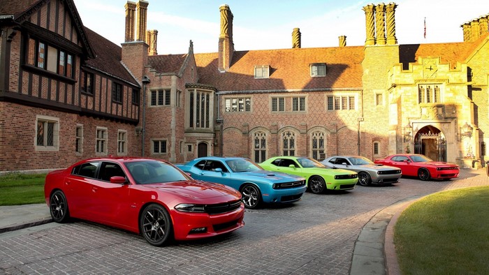 Dodge cars parked in front of a historic building