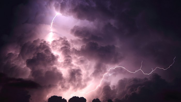 Purple storm with lightning and dark clouds