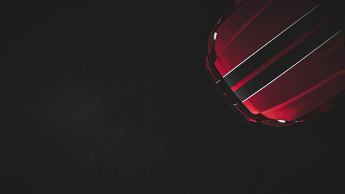 Red Ford Mustang with racing stripes, top view