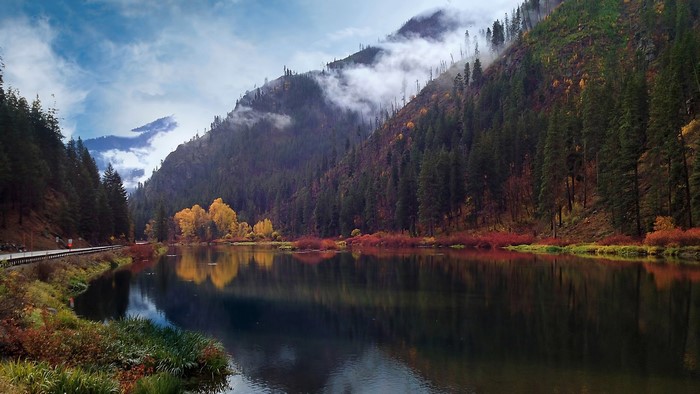 River flowing through a mountain valley in fall