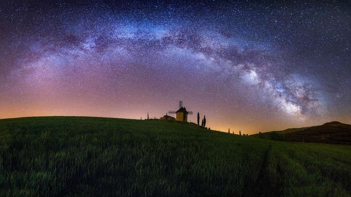 Windmill under the Milky Way at night