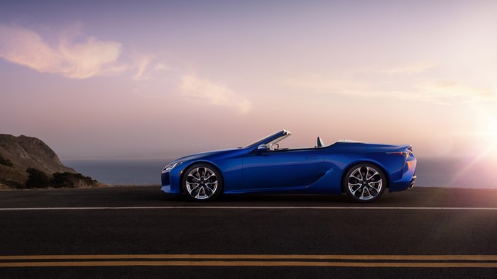 Blue Lexus LC-500 Convertible on a Coastal Road at Sunset