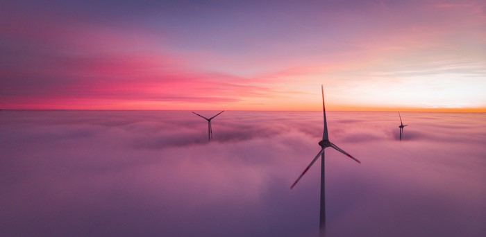 Windmills in clouds at sunset