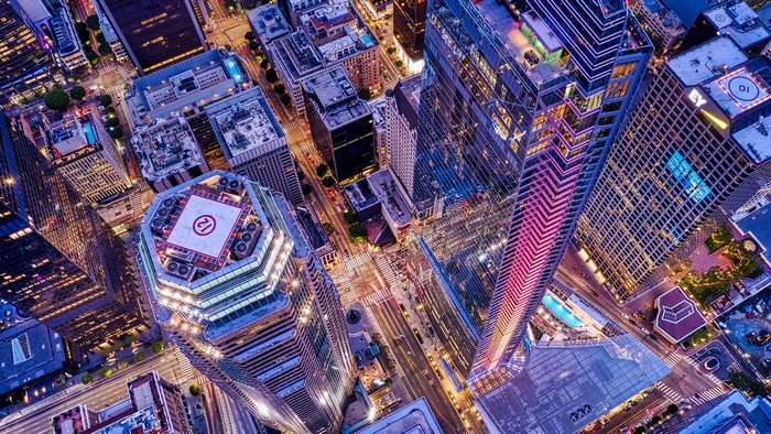 Aerial view of a city at night with illuminated skyscrapers
