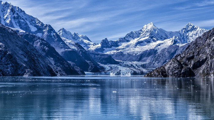 Snowy mountains and glacier over a body of water