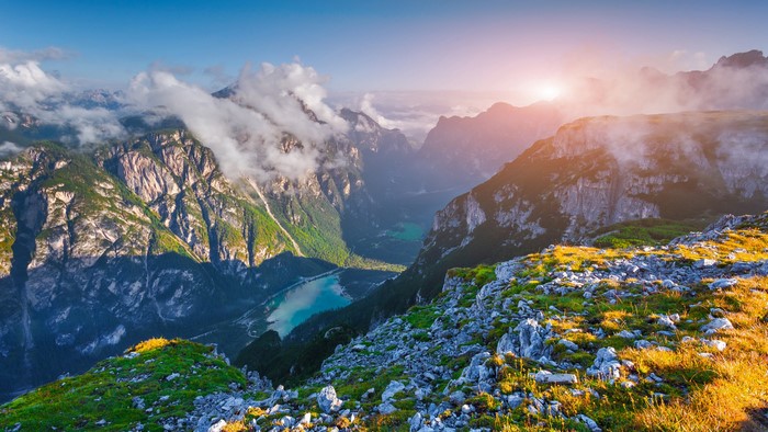 Mountain landscape with lake and sun in the Dolomites