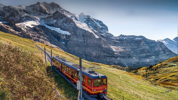 Red train on a mountain railway in Switzerland