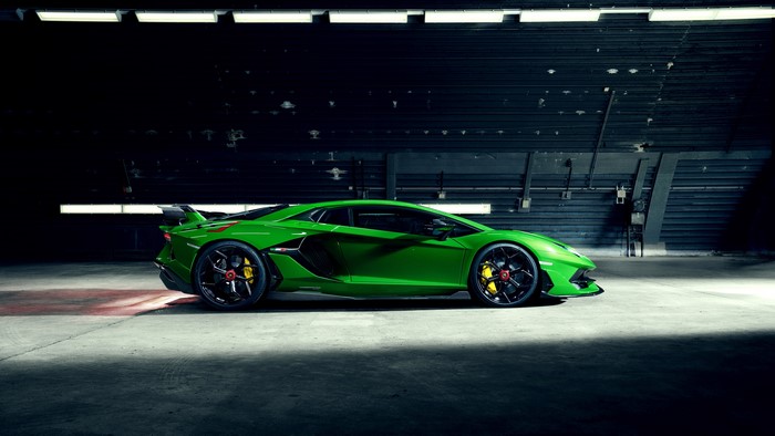 Green Lamborghini Aventador SVJ in a hangar