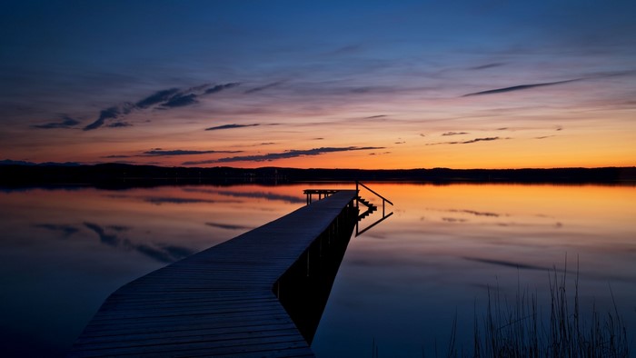 Wooden pier on a lake at sunset in Bavaria, Germany