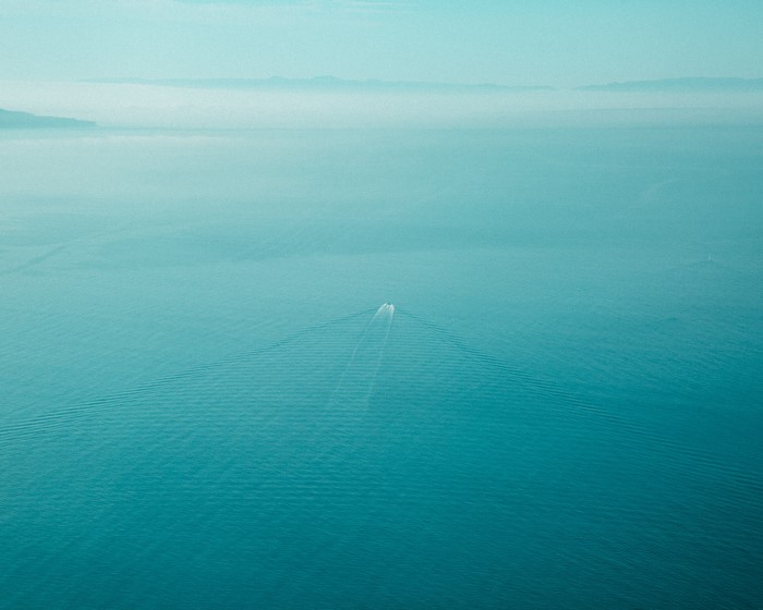 Boat on the water with fog in the distance