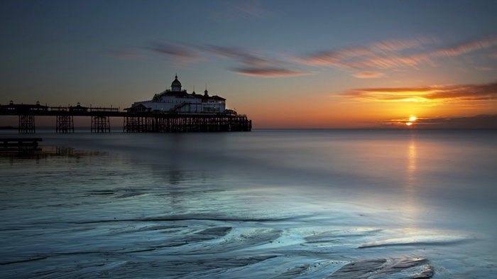 Pier at sunset over the ocean