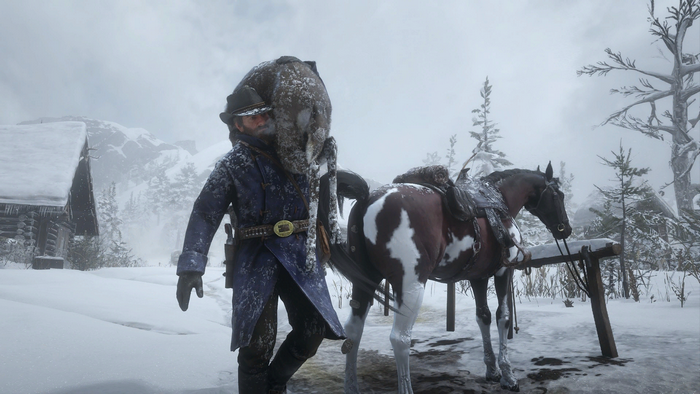 Arthur Morgan from Red Dead Redemption 2 with a horse in the snow