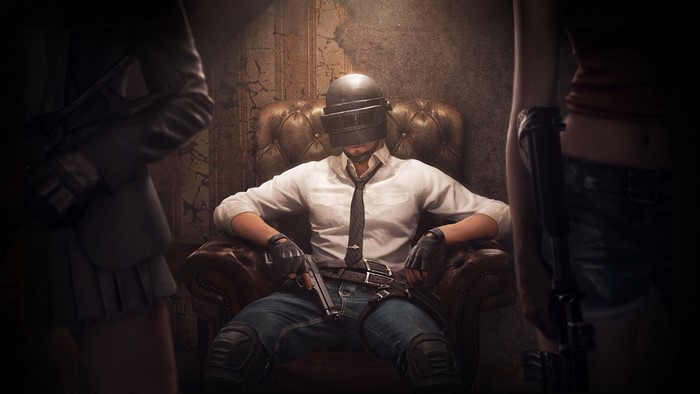 Player from PUBG sitting in a chair with guns