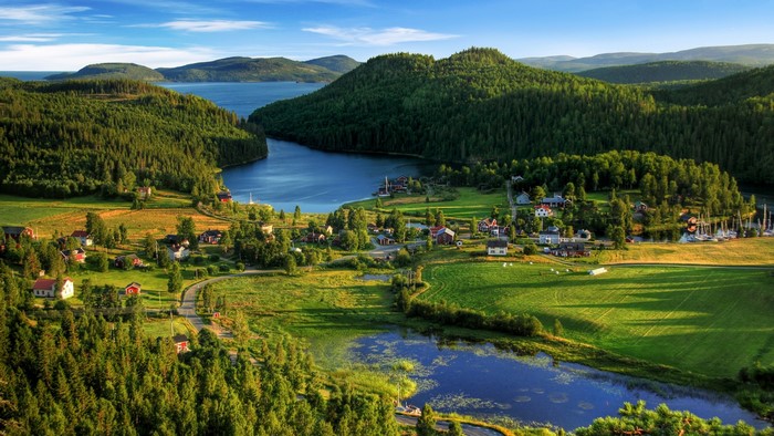 Village by a lake in a forest landscape in Sweden