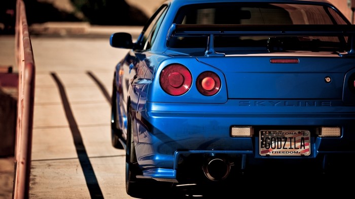Blue Nissan Skyline GT-R R34 with Godzilla license plate
