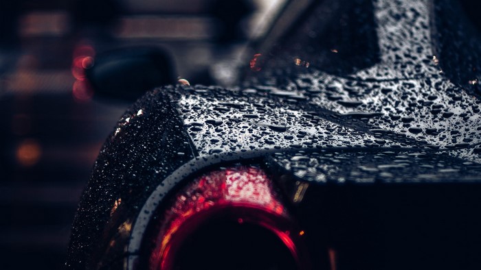Close-up of a wet Ferrari car tail light