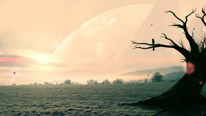 Surreal landscape with a large planet and a dead tree