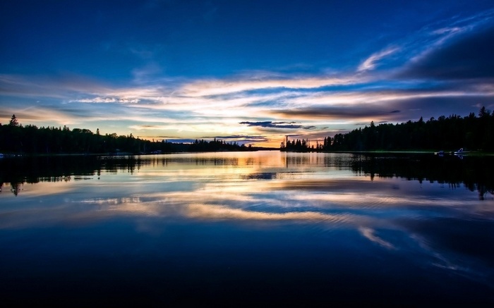 Sunset over a calm lake with reflections