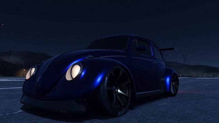 Customized blue Volkswagen Beetle at night