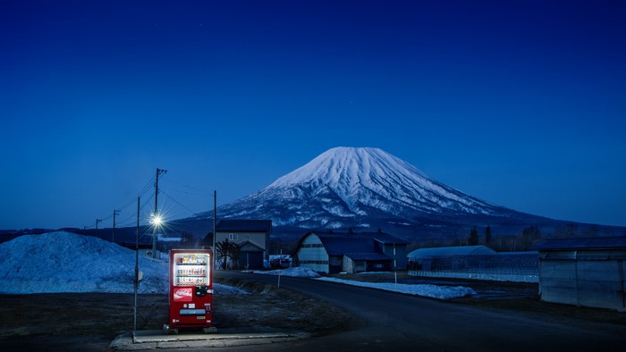 Vending machine at night with Mount Fuji
