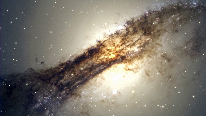 Galaxy with dark dust lanes and stars