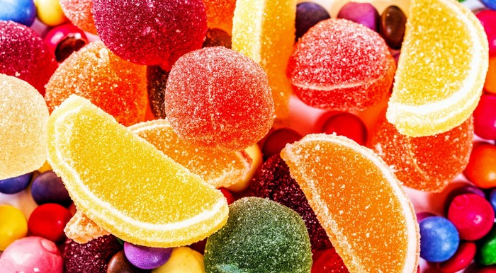 Close-up of colorful sugar-coated candies and jelly fruit slices
