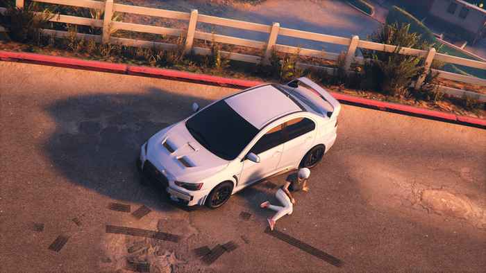 White Mitsubishi Lancer Evo X with person on ground in FiveM