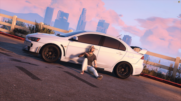 Person sitting by a white Mitsubishi Lancer Evo X in Grand Theft Auto V