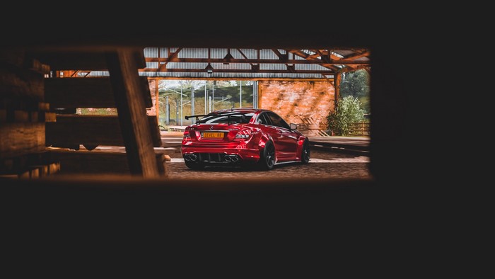 Red Mercedes C63 AMG Black Series in a barn