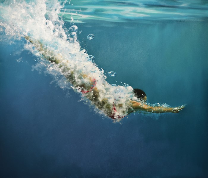 Woman diving underwater in a swimming pool