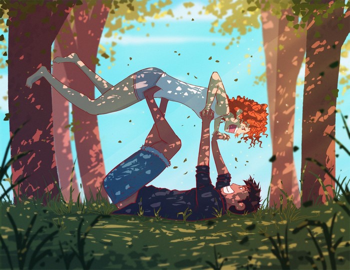 Couple doing acroyoga in a sun-dappled forest