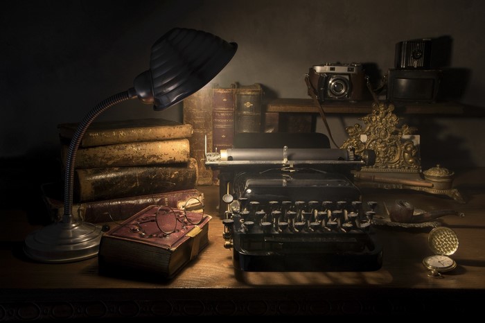 Vintage desk with typewriter, camera, and books