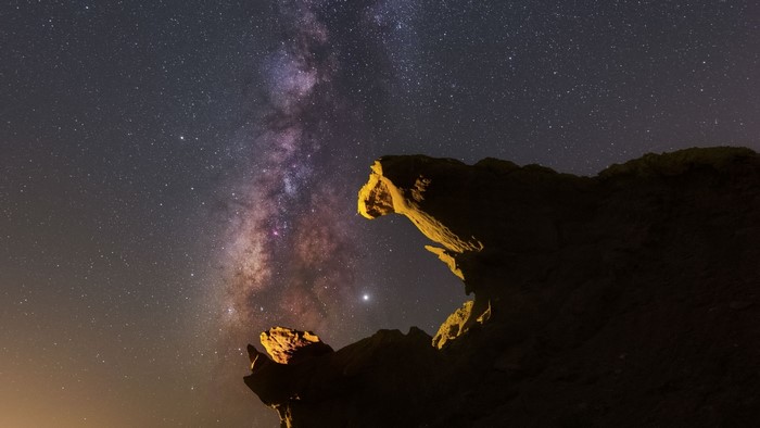 Milky Way and Jupiter over rock formations